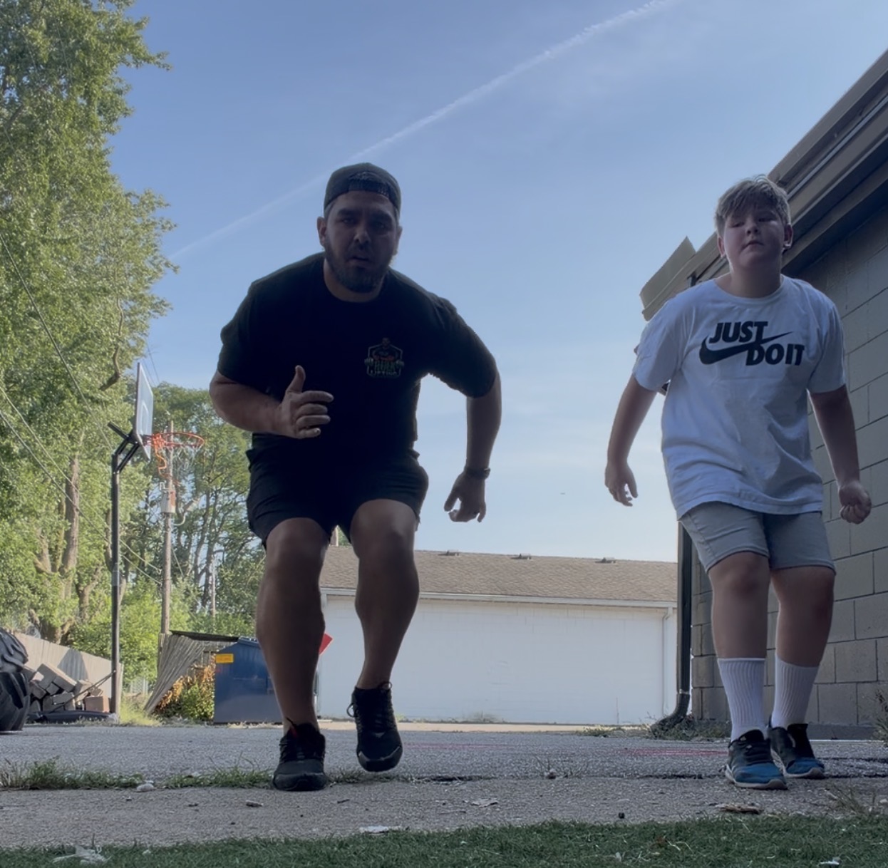 Joshua coaching a client through sprint starts outside the Indianapolis gym